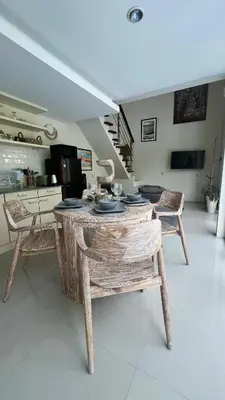 a room with a table and chairs in a kitchen at Oasis Villa Canggu in Kerobokan