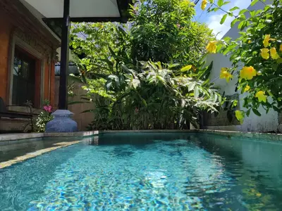a swimming pool in the middle of a garden at Casa Yenny Balinese Style Villa by GLOBALSTAY - Seminyak x Kuta x Canggu in Seminyak