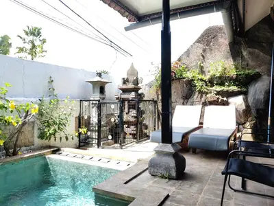 a patio with a swimming pool and a fence at Casa Yenny Balinese Style Villa by GLOBALSTAY - Seminyak x Kuta x Canggu in Seminyak