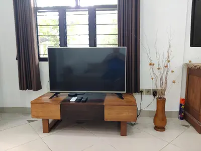 a flat screen tv sitting on top of a wooden table at Casa Yenny Balinese Style Villa by GLOBALSTAY - Seminyak x Kuta x Canggu in Seminyak