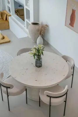 a white table and chairs with a vase of flowers on it at Villa Golden Canggu - Modern Chic 2BR Villa Near Finns Recreation Club in Canggu