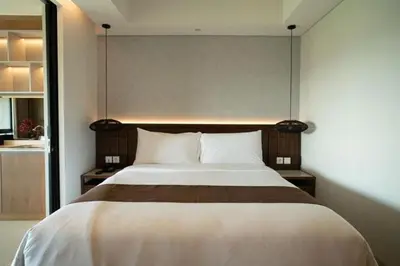 a bedroom with a large bed in a room at Lavaya Resort Nusa Dua Bali in Nusa Dua
