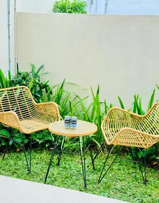 three chairs and a table with two glasses on it at Y&J in Seminyak