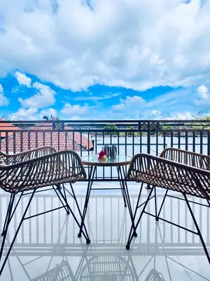a patio with two chairs and a table on a balcony at Y&J in Seminyak