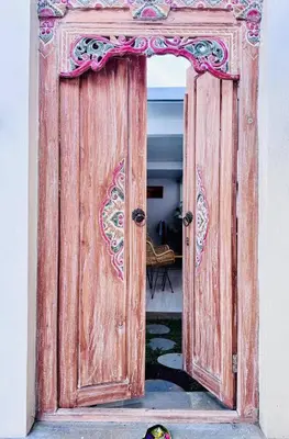 an open wooden door in a room at Y&J in Seminyak