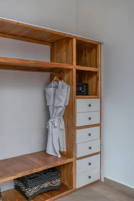 a closet with wooden shelves and drawers at Villa Vida Mira - Elegant 4BR Beachside Villa in Canggu in Canggu