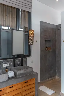 a bathroom with a sink and a tv on a counter at Villa Vida Mira - Elegant 4BR Beachside Villa in Canggu in Canggu