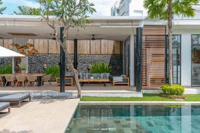 a house with a swimming pool and a patio at Villa Vida Mira - Elegant 4BR Beachside Villa in Canggu in Canggu