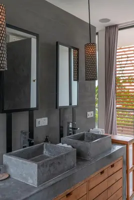 a bathroom with two sinks and two mirrors at Villa Vida Mira - Elegant 4BR Beachside Villa in Canggu in Canggu
