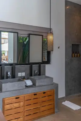 a bathroom with two sinks and a mirror at Villa Vida Mira - Elegant 4BR Beachside Villa in Canggu in Canggu