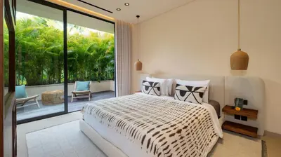 a bedroom with a bed and a large window at Villa Fiji by Villa Finder in Canggu