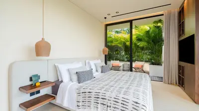 a bedroom with a white bed and a large window at Villa Fiji by Villa Finder in Canggu