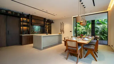 a kitchen and dining room with a table and chairs at Villa Fiji by Villa Finder in Canggu