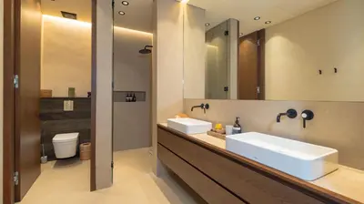 a bathroom with two sinks and a mirror at Villa Fiji by Villa Finder in Canggu