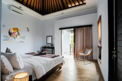 a bedroom with a bed and a table and a chair at Villa Narada - Convenient Location - Private Pool - 3BR Villa in Seminyak