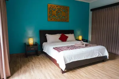 a bedroom with a large bed with a blue wall at Villa Narada - Convenient Location - Private Pool - 3BR Villa in Seminyak