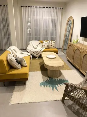 a living room with a yellow couch and a coffee table at Villa EL NIS - LEGIAN - 4 Bedroom - 4 Bathroom - Luxury in Legian