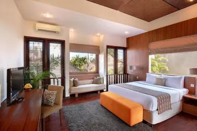 a bedroom with a large bed and a television at Cozy 2 BR Private Pool Villa in Seminyak