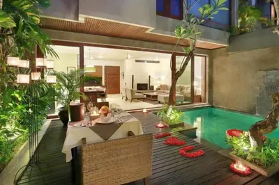 a living room with a pool and a dining table at Cozy 2 BR Private Pool Villa in Seminyak