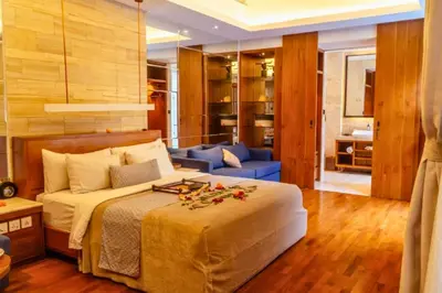 a bedroom with a bed and a living room at Smart 1 BR Villa with Private Pool in Seminyak