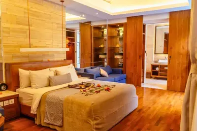 a bedroom with a large bed and a blue couch at Smart 1 BR Villa with Private Pool in Seminyak