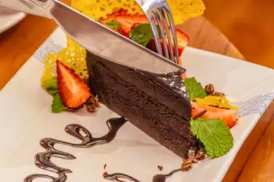 a piece of chocolate cake on a plate with a fork at Smart 1 BR Villa with Private Pool in Seminyak