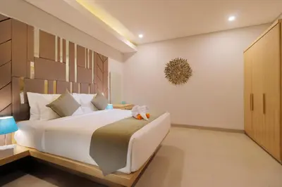 a bedroom with a large bed with a stuffed animal on it at Sudha Villa Bali A in Seminyak