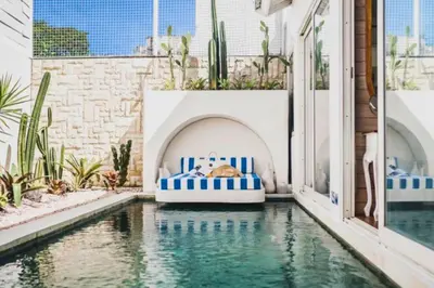 a pool with a bed in the middle of a building at Romantic 1 BR Villa with Private Pool in Seminyak