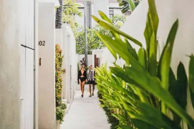 two people walking down a narrow alley with plants at Romantic 1 BR Villa with Private Pool in Seminyak