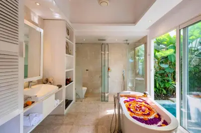 a bathroom with a bath tub and a shower at Romantic 1 BR Villa with Private Pool in Seminyak
