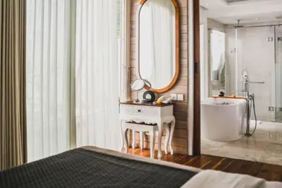 a bathroom with a sink and a tub and a mirror at Romantic 1 BR Villa with Private Pool in Seminyak