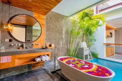a bathroom with a tub and a sink and a mirror at Modern 1 BR Villa with Private Pool in Seminyak