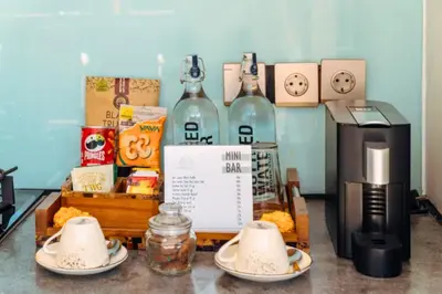 a table with two plates of food and wine bottles at Modern 1 BR Villa with Private Pool in Seminyak