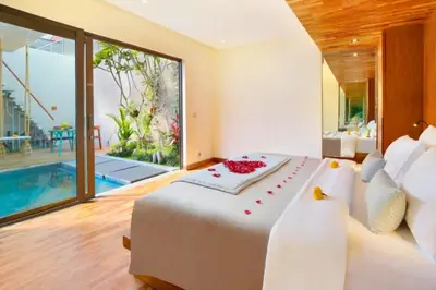 a bedroom with a large bed and a swimming pool at Modern 1 BR Villa with Private Pool in Seminyak