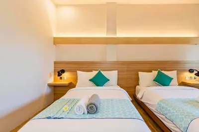 a bedroom with two beds with towels on them at Luxury 1 BR Deluxe Twin Room in Canggu