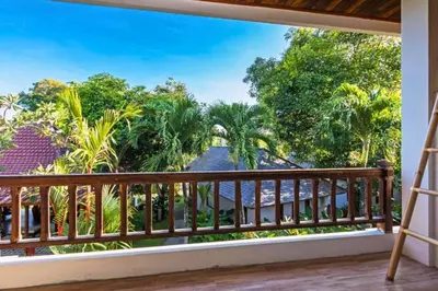 a room with a balcony with a view of the ocean at Luxury 1 BR Deluxe Twin Room in Canggu