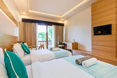 a hotel room with two beds and a desk at Luxury 1 BR Deluxe Twin Room in Canggu