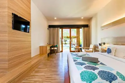 a hotel room with two beds and a television at Beautiful 1BR Deluxe Double Room in Canggu