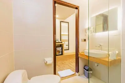 a bathroom with a sink and a toilet and a mirror at Beautiful 1BR Deluxe Double Room in Canggu