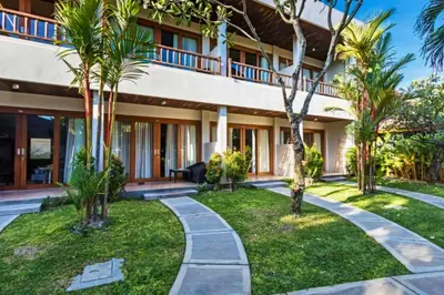 a resort with palm trees and a walkway at Beautiful 1BR Deluxe Double Room in Canggu