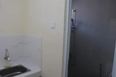 a bathroom with a sink and a shower at Griya Mozaik in Jimbaran