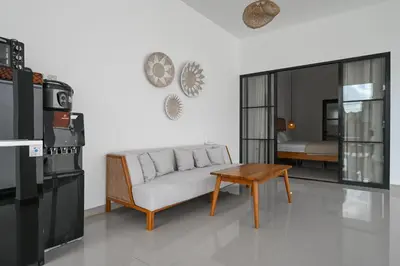 a living room with a couch and a table at The Samsara Jimbaran Villa in Jimbaran