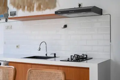 a kitchen with a sink and a stove at The Samsara Jimbaran Villa in Jimbaran
