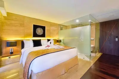 a large bedroom with a large bed and a shower at Antariksha 1 BR Superior Room in Seminyak