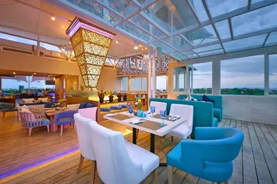 a restaurant with blue chairs and a table and tablesktop at Antariksha 1 BR Superior Room in Seminyak