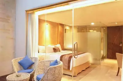 a hotel room with a bed and a glass wall at Damarlangit 1 BR Superior Terrace in Seminyak