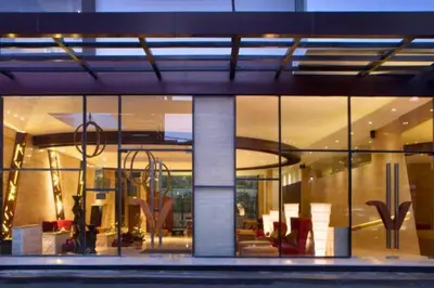 a large building with glass windows and furniture in it at Damarlangit 1 BR Superior Terrace in Seminyak