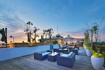 a rooftop patio with blue couches and plants at Damarlangit 1 BR Superior Terrace in Seminyak
