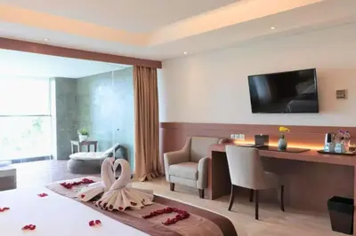 a hotel room with a bed and a desk at Viorel 1 BR Whirlpool Suite Room in Seminyak
