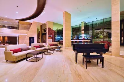 a living room with a piano and couches at Viorel 1 BR Whirlpool Suite Room in Seminyak